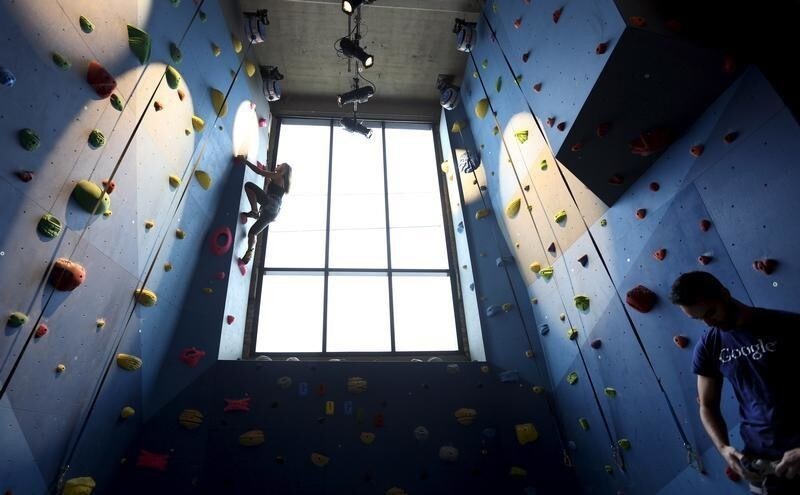 Google employee Dalya Gershtein, a software engineer, scales the climbing wall inside the gym of Google's new Canadian engineering headquarters in Kitchener-Waterloo, Ontario January 14, 2016. REUTERS/Peter Power - GF20000095157