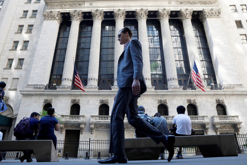 A man walks past the New York Stock Exchange in New York City, U.S., May 17, 2017.