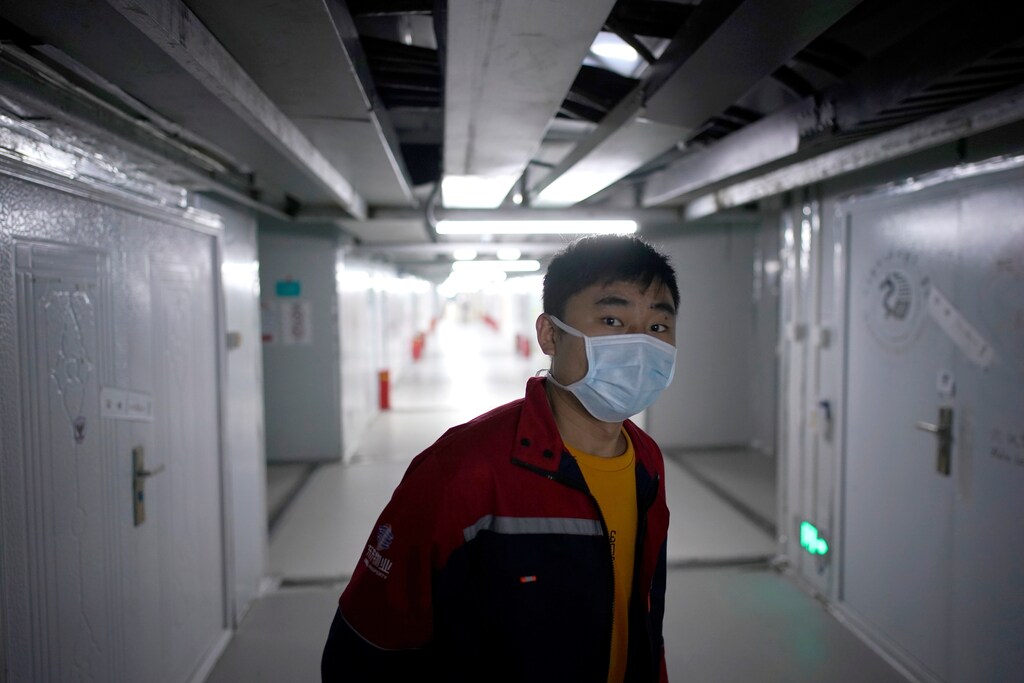 A staff member wearing a face mask is seen near closed wards inside the Leishenshan Hospital, a makeshift hospital for treating patients with the coronavirus disease (COVID-19), in Wuhan, Hubei province, China April 11, 2020. REUTERS/Aly Song - RC242G9XKX57