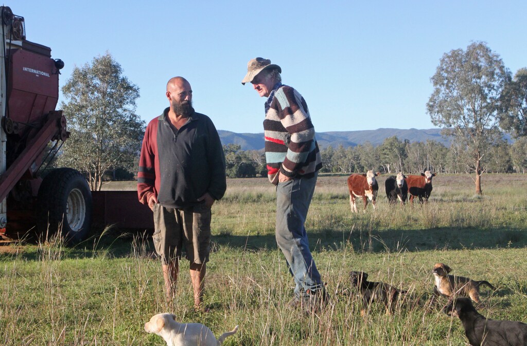 Australian farmer Cliff Wallace (R) stands next to anti-coal activist Murray Drechsler on the farmland Wallace is donating for use by environmentalists fighting development of a large open pit coal mine in Maules Creek, June 3, 2014. To reach the farm drivers must pass through a police checkpoint, where vehicles are searched for ropes and chains that could be used to climb trees or lock onto mining equipment - traditional guerilla protest tactics used against coal mines. Taking on Australia's powerful coal sector was once left to environmentalists like Greenpeace and the World Wildlife Fund, but now the anti-coal movement is attracting wider support, from farmers to banks and investment funds striving to be seen as ethical investors and not contributing to global pollution. Picture taken June 3, 2014. To match Feature AUSTRALIA-COAL/ REUTERS/Jim Regan (AUSTRALIA - Tags: ENVIRONMENT BUSINESS COMMODITIES ANIMALS) - RTR3VCQT