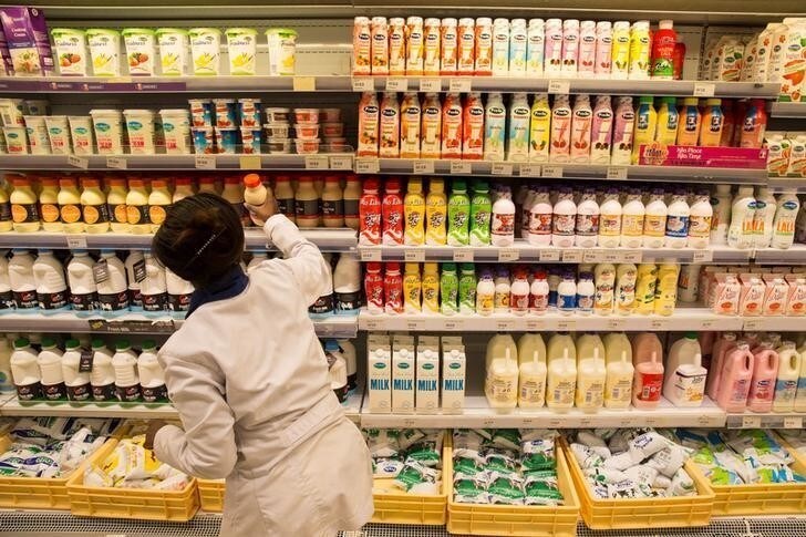 An employe restocks the dairy products section at a supermarket in Nairobi, Kenya May 8, 2017. Picture taken May 8, 2017. REUTERS/Baz Ratner
