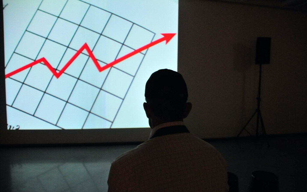 A man looking at a projected screen with an upwards