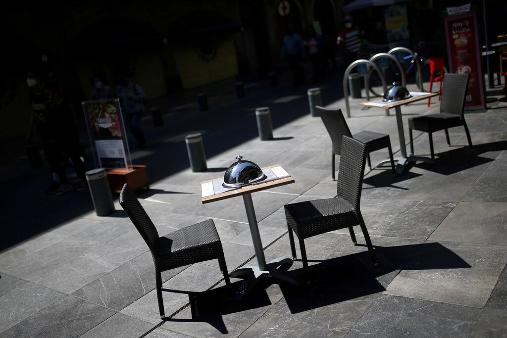 Empty chairs in a restaurant are pictured on a street in downtown Mexico City, as the commercial activities remain in a gradual lockdown due to the coronavirus disease (COVID-19) outbreak, Mexico, February 5, 2021. REUTERS/Edgard Garrido TPX IMAGES OF THE DAY - RC2MML9WFTAC