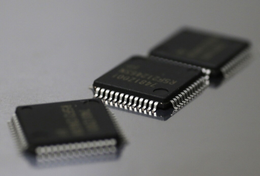 Renesas Electronics Corp's microcontroller chips are seen in this illustrative photograph taken in Tokyo May 24, 2012. Japan's loss-making Renesas Electronics Corp said on Thursday it will tie up with Taiwan Semiconductor Manufacturing Co in the microchip business as it struggles to keep up with aggressive rivals like Samsung Electronics. REUTERS/Kim Kyung-Hoon (JAPAN - Tags: BUSINESS SCIENCE TECHNOLOGY) - GM1E85O1M4D02