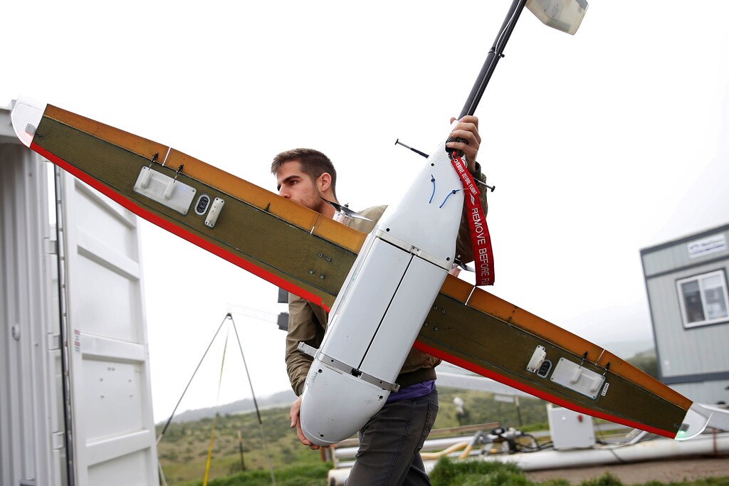 Ryan Oksenhorn, a software engineer with Zipline International, carries a Zipline aerial delivery drone before a flight demonstration at an undisclosed location in the San Francisco Bay Area, California, U.S., May 5, 2016.