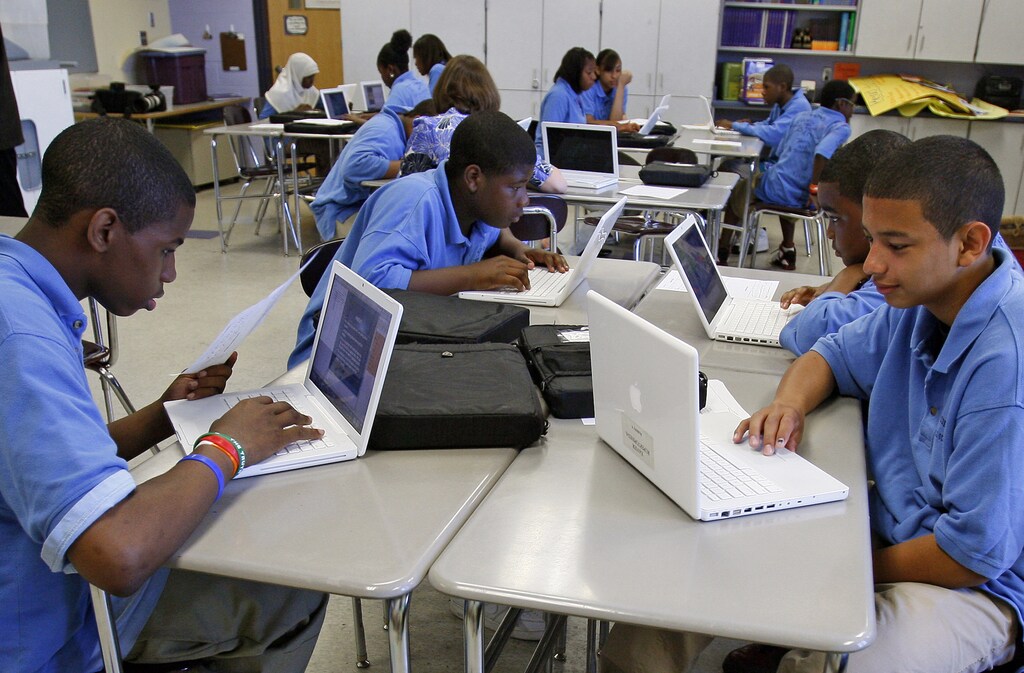 Students at the Lilla G. Frederick Pilot Middle School work on their laptops during a class in Dorchester, Massachusetts June 20, 2008. From online courses to kid-friendly laptops and virtual teachers, technology is spreading in America's classrooms, reducing the need for textbooks, notepads, paper and in some cases even the schools themselves. To match feature USA-EDUCATION/TECHNOLOGY REUTERS/Adam Hunger (UNITED STATES) - GM1E4770OG001