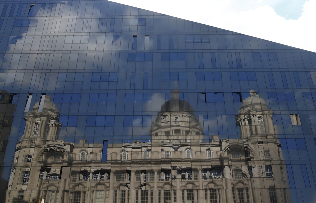 The Port of Liverpool building is seen reflected in the windows of a modern office block in Liverpool northern Britain, September 16 , 2015. The Port of Liverpool building was built in 1907 and is the former home of the Mersey Docks and Harbour Board. REUTERS/Phil Noble - LR2EB9G12UFD7