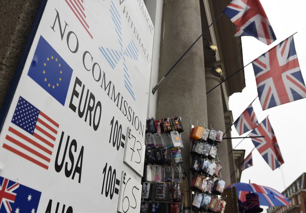 A rates board is seen outside of a Forex outlet in central London, Britain.