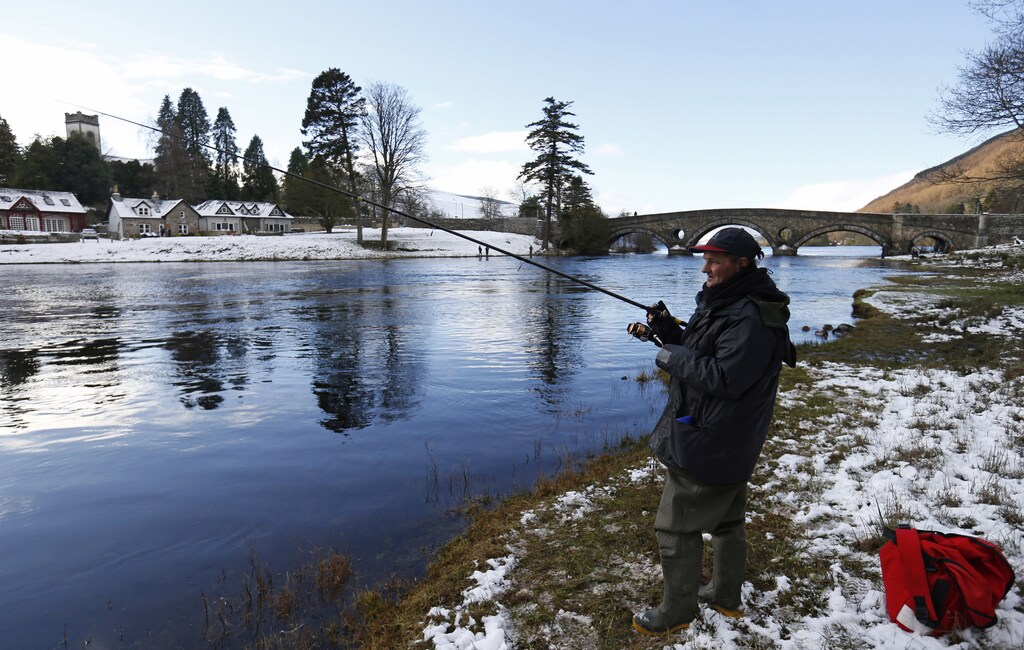 An angler fishes on the opening day of the salmon fishing season on the River Tay at Kenmore in Scotland, Britain January 15, 2016. REUTERS/Russell Cheyne - RTX22J9O