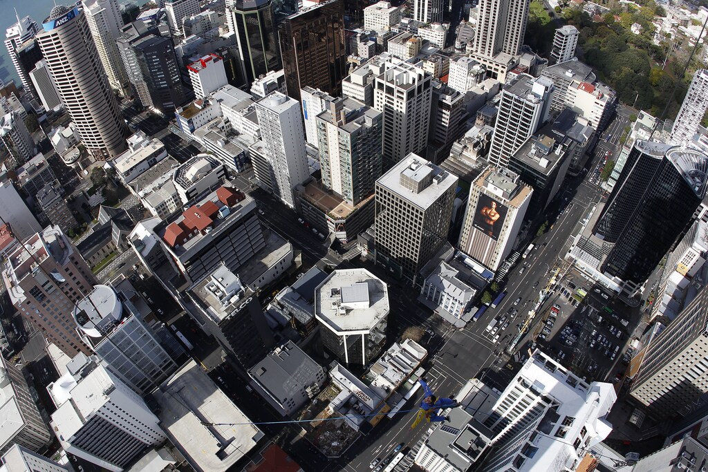 Skyjumper Brad Smith performs a skyjump atop the Sky Tower in Auckland September 28, 2011. Picture taken with a fisheye lens. REUTERS/Stefan Wermuth (NEW ZEALAND) - SR1E79S0GKK1B