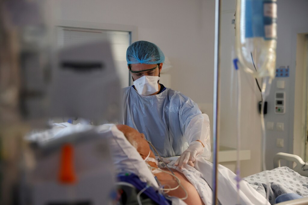A doctor, wearing a protective mask and a protective suit, works in the Intensive Care Unit (ICU) where patients suffering from the coronavirus disease (COVID-19) are treated at the Bethune-Beuvry hospital in Beuvry, France, October 16, 2020. REUTERS/Pascal Rossignol - RC2PJJ9WOI4M