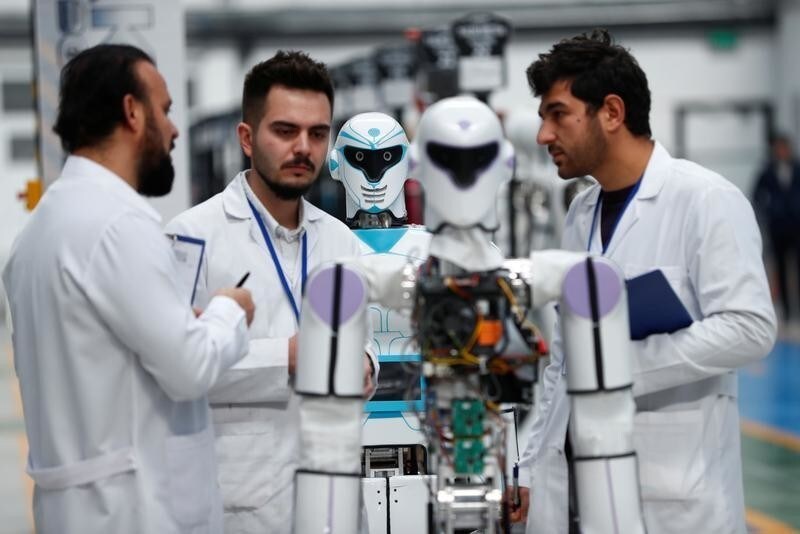 Ozgur Akin, Chairman and founder of Akinsoft, and engineers check an "ADA GH5" humanoid hybrid robot at Akinrobotics, the country's first-ever factory to mass produce humanoid robots, in Konya, Turkey, December 8, 2017. Picture taken December 8, 2017. REUTERS/Murad Sezer - RC13E38D54C0