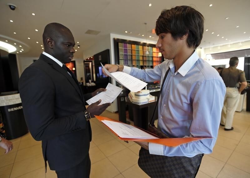 Christopher (R), a 24-year-old unemployed Frenchman, submits his curriculum vitae to a shopkeeper as he looks for a job in Marseille June 17, 2013. In addition to making job applications, once a month Christopher meets with a job councillor at a Mission Locale for Employment (Youth Employment Agency) which has yet to lead to permanent employment. On June 26, 2013, French labour ministry data showed the number of unemployed people in mainland France was stable in May with a negligible rise of 100 people, just nudging the total to a new all-time high of 3,264,500. Picture taken June 17, 2013 REUTERS/Jean-Paul Pelissier (FRANCE - Tags: POLITICS BUSINESS EMPLOYMENT) - RTX111WQ