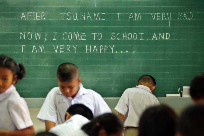 Thai students stand in front of a chalkboard with a message on the tsunami at a school in the tsunami-damaged village of Kamala, Phuket. Thai students stand in front of a chalkboard with a message on the tsunami at a school in the tsunami-damaged village of Kamala on the Thai island of Phuket February 2, 2005. As many as 90 percent of the survivors of the Indian Ocean tsunami might have suffered some form of psychological trauma from the disaster, with children particularly at risk, mental health experts said on Wednesday.