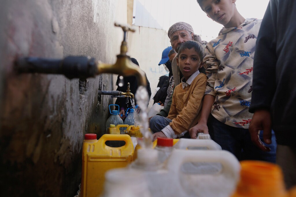 People collect drinking water from charity tap amid fears of a new cholera outbreak in Sanaa, Yemen November 5, 2018. Picture taken November 5, 2018. REUTERS/Khaled Abdullah - RC1E89B54FC0