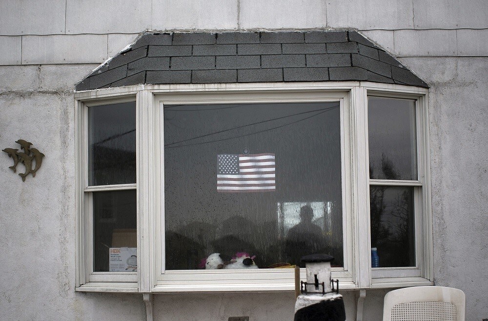 The silhouette of a man is seen inside a home in the Breezy Point section of the borough of Queens, six months after the landfall of Superstorm Sandy, in New York, April 29, 2013. REUTERS/Shannon Stapleton (UNITED STATES - Tags: DISASTER ENVIRONMENT) - RTXZ3RM