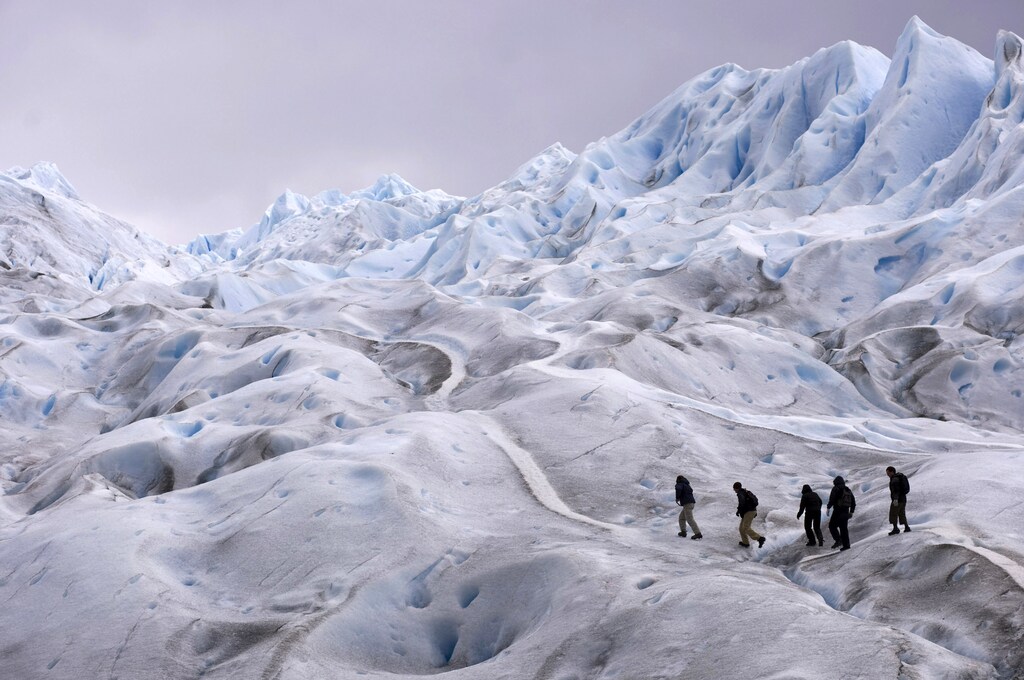 Climbers trek on Argentina's Perito Moreno glacier near the city of El Calafate, in the Patagonian province of Santa Cruz, December 16, 2009. Scientists warn that glaciers in the Andes are melting because of the effects of climate change. According to studies, these accumulations of ice are thawing at a pace so fast that they could disappear in 25 years. REUTERS/Marcos Brindicci (ARGENTINA) FOR BEST QUALITY IMAGE ALSO SEE GF2E5CL1M6D01 - GM1E5CH0R8J01