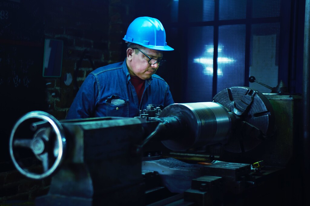 A metal worker at a machine.