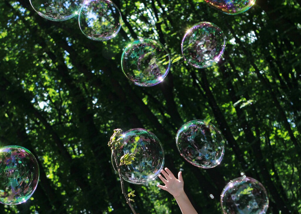 A child plays with soap bubbles at an event to support autistic children and their families in a park in Kiev May 28, 2013. The event, which was organised by several local charities, gave autistic children and their families the opportunity to spend a day in the park playing with soap bubbles as clowns and other performers entertained them. REUTERS/Gleb Garanich (UKRAINE - Tags: SOCIETY HEALTH) - GM1E95S1NMQ01