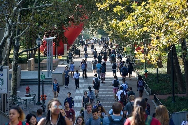 Students walk between classes on the Locust Walk on the campus of the University of Pennsylvania in Philadelphia, Pennsylvania, U.S., September 25, 2017. REUTERS/Charles Mostoller