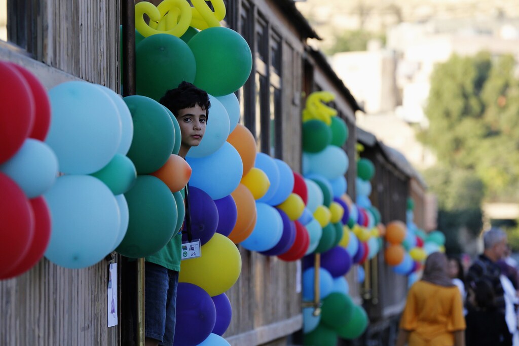 A boy looks out of a train before his meal for iftar, the breaking of fast meal, as he joins children from the Al-Baqaa Palestinian refugee camp during the Muslim fasting month of Ramadan in Amman July 7, 2014.
