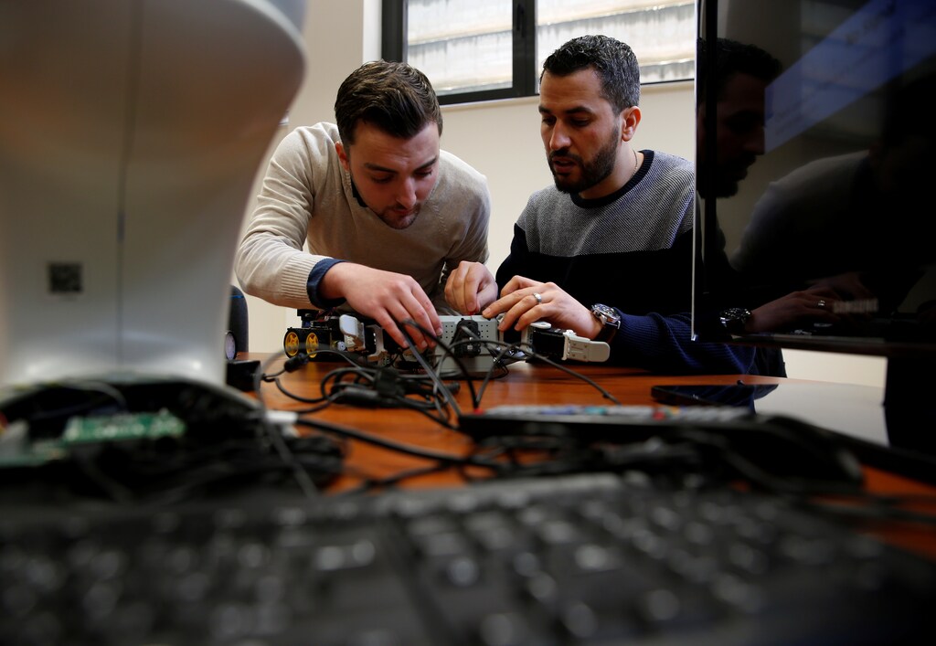 Research support officers and PhD students Luca Bondin and Foaad Haddad work on an artificial intelligence project to train robots to autonomously carry out various tasks, at the Department of Artificial Intelligence in the Faculty of Information Communication Technology at the University of Malta in Msida, Malta February 8, 2019.