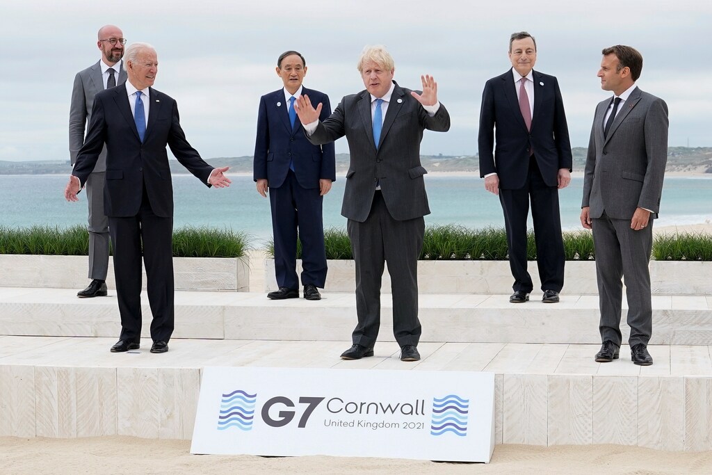 U.S. President Joe Biden and British Prime Minister Boris Johnson gesture as they pose for a family photo with G-7 leaders; European Council President Charles Michel, Japan's Prime Minister Yoshihide Suga, Italy's Prime Minister Mario Draghi and French President Emmanuel Macron at the G-7 summit, in Carbis Bay, Cornwall, Britain June 11, 2021. Patrick Semansky/Pool via REUTERS TPX IMAGES OF THE DAY - RC2DYN9SX06W