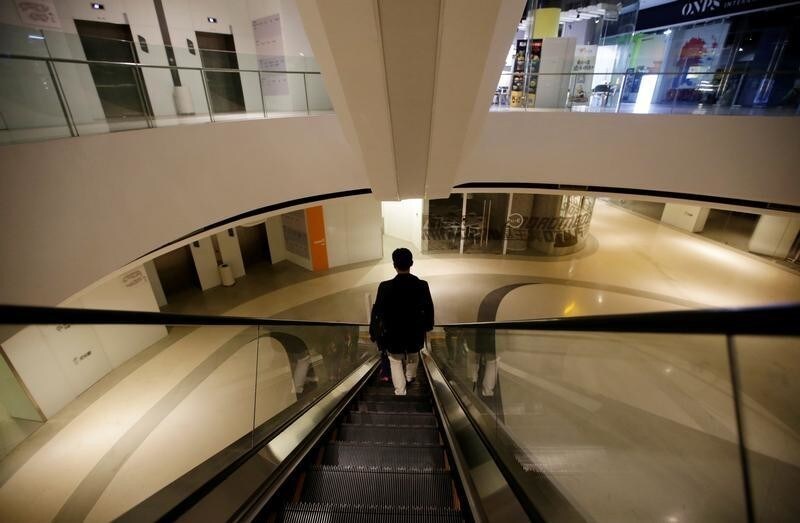 Han Liqun, a HR manager of RenRen Credit Management Co., leaves office for home after finishing work at midnight, in Beijing, China, April 19, 2016. Office workers sleeping on the job is a common sight in China, where a surplus of cheap labour can lead to downtime at work. But in China's technology sector, where business is growing faster than many start-up firms can hire new staff, workers burn the midnight oil to meet deadlines and compete with their rivals. Some companies provide sleeping areas and beds for workers to rest during late nights. REUTERS/Jason Lee SEARCH "JASON SLEEP" FOR THIS STORY. SEARCH "THE WIDER IMAGE" FOR ALL STORIES - RTX2DQ8D