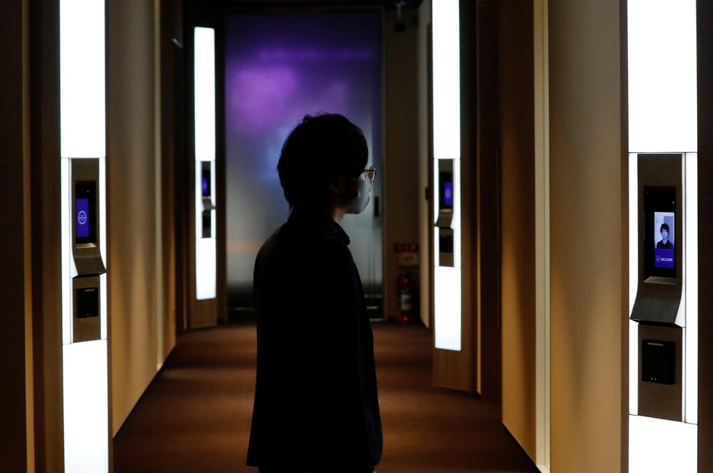NEC's Shinya Takashima demonstrates a facial recognition system that identifies people even when they are wearing masks, amid the coronavirus disease (COVID-19) outbreak, at its headquarters in Tokyo, Japan, January 6, 2021. Picture taken on January 6, 2021. REUTERS/Kim Kyung-Hoon - RC2R2L9LNA38