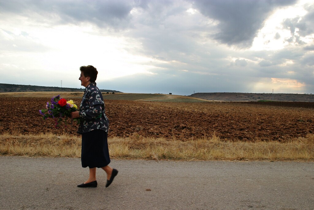 Seventy-six year-old Isidora Langa Morales walks to the cementery ofLuzaga, Castilla La Mancha, with a bouquet of flowers she grows in herown garden, September 28, 2003. "I bring flowers for my husband's tombevery Sunday. This walk is going to change so much if they build thosewindmills," Langa Morales says. Like most residents of Luzaga, thesmall Spanish village where she was born and she raised her family, sheopposes the plan of a Danish company to install 33 modern turbines toturn wind into energy. Spain is the world's second largest producer ofwind power. TO MATCH FEATURE ENVIRONMENT-SPAIN-ENERGY REUTERS/SusanaVera REUTERSPH/CRB - RP4DRHZLLNAA