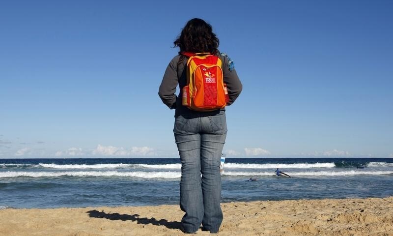 A World Youth Day participant looks out to see at Sydney's famous Bondi Beach July 16, 2008. Thousands of young pilgrims have flocked to Sydney Harbour for the Catholic church's biggest youth festival which includes an outdoor mass by Pope Benedict on Sunday. REUTERS/Tim Wimborne (AUSTRALIA) - GM1E47G17TS01