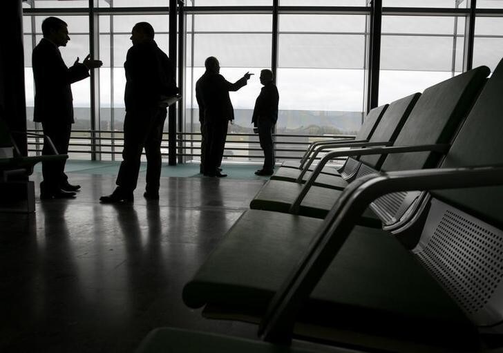 Unidentified people gesture after the opening of the new Terminal 10 at the Cointrin airport in Geneva November 20, 2008.