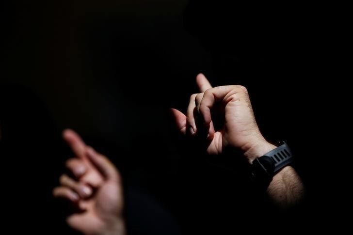 Sergio Colas uses sign language while having lunch with other deaf friends during the start of the San Fermin festival in Pamplona, northern Spain, July 6, 2016. REUTERS/Susana Vera SEARCH "SERGIO COLAS" FOR THIS STORY. SEARCH "THE WIDER IMAGE" FOR ALL STORIES.