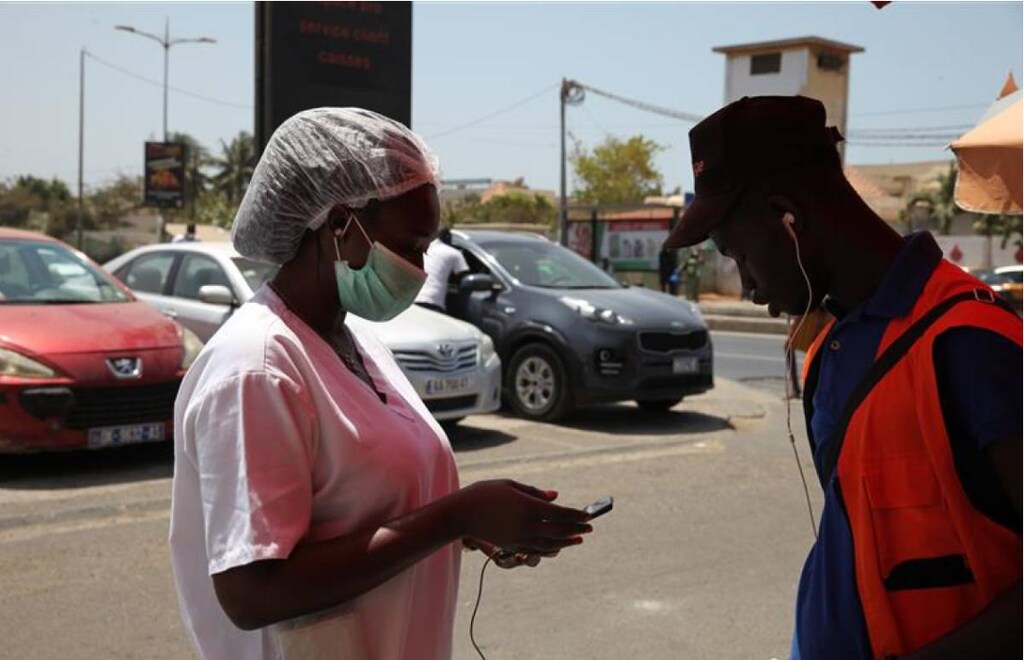 Penda Kande refills her mobile money account with an agent in Senegal's capital, Dakar. March 27, 2020.