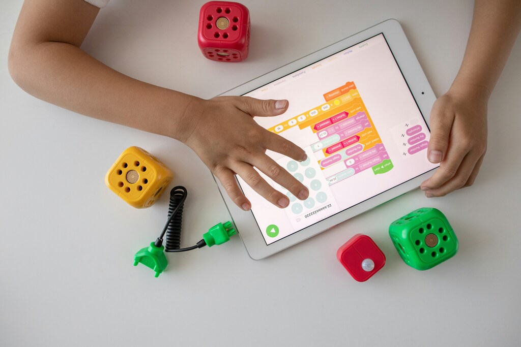 Child using a tablet for visual programming.