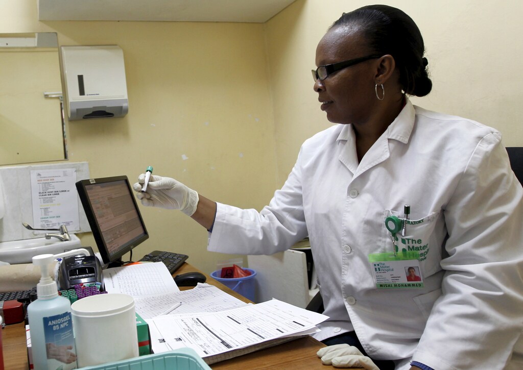 Mishi Mohammed, a phlebotomist, holds a blood sample from a woman to test for HIV at the Mater Hospital in Kenya's capital Nairobi, September 10, 2015. Most of the 3,000 patients at Mater Hospital's Comprehensive Care Clinic, dedicated to HIV/AIDS treatment, come from nearby shanty towns. In Kenya, HIV prevalence among adults has almost halved since the mid-1990s to 5.3 percent in 2014, according to UNAIDS. Yet HIV/AIDS remains the leading cause of death in Kenya, responsible for nearly three in 10 deaths in the east African country, where 1.6 million Kenyans are infected, government data in 2014 shows. Picture taken September 10, 2015. To match Special Series DEVELOPMENT-GOALS/KENYA-HEALTH REUTERS/Thomas Mukoya - GF10000201313