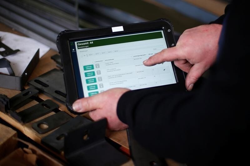 Ronny Mucha uses a new tablet computer for his work at the machine-building company Zemmler Siebanlagen in Massen, Germany, March 22, 2018. Picture taken March 22, 2018.
