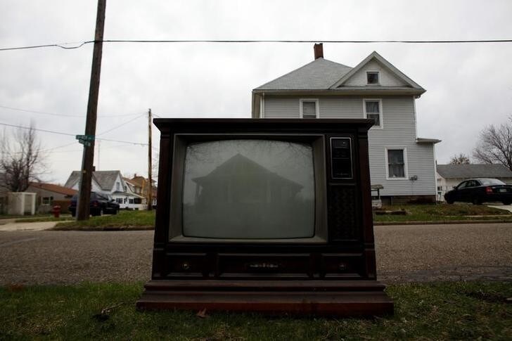 A house is reflected on the screen of a discarded television in Beach City, Ohio April 6, 2011. The city is a part of America's Midwestern "Rust Belt", the heartland of the country and home to big unionized manufacturers like the auto and steel industries. REUTERS/Eric Thayer (UNITED STATES - Tags: TRANSPORT SOCIETY BUSINESS)