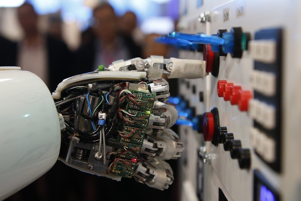 The hand of humanoid robot AILA (artificial intelligence lightweight android) operates a switchboard during a demonstration by the German research centre for artificial intelligence at the CeBit computer fair in Hanover March, 5, 2013. The biggest fair of its kind open its doors to the public on March 5 and will run till March 9, 2013. REUTERS/Fabrizio Bensch (GERMANY - Tags: POLITICS) - RTR3ELOG