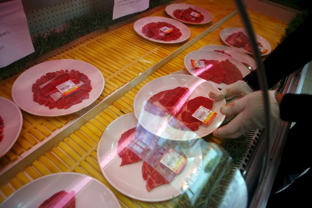 A man displays cuts of beef at a BBQ restaurant in Hongseong, South Korea, September 16, 2015.