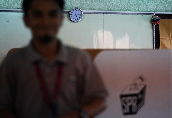 A clock hangs on a wall at a polling station after polls closed during the general election in Kuala Lumpur, Malaysia, May 9, 2018. REUTERS/Athit Perawongmetha