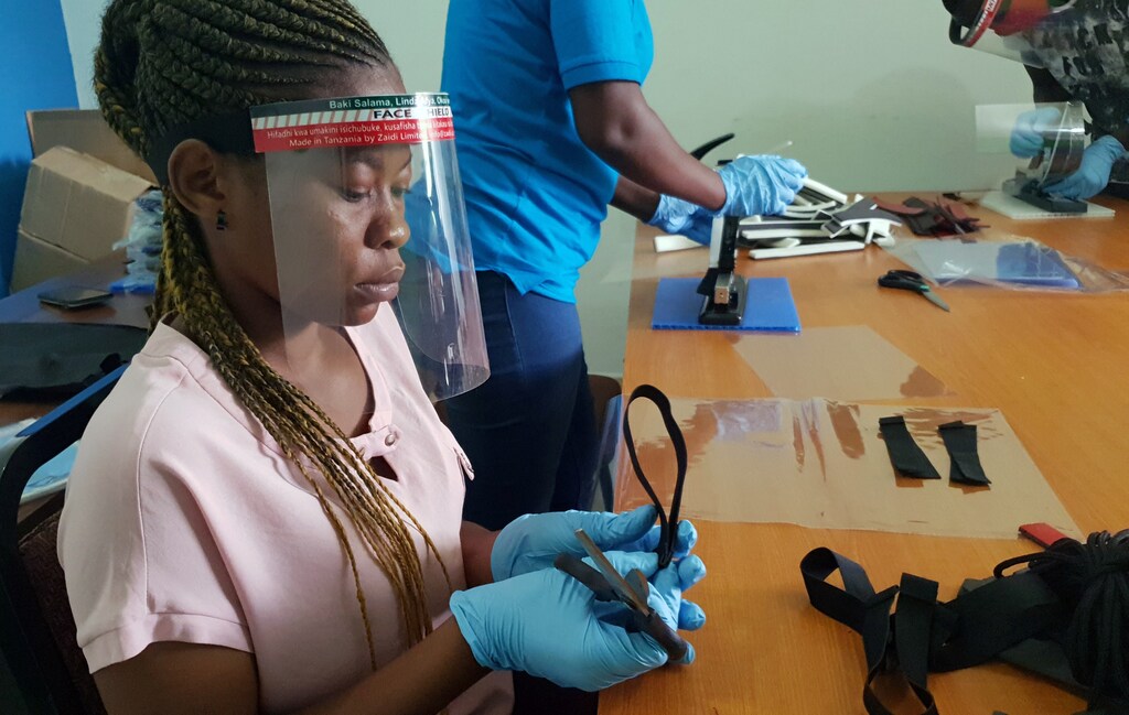 Workers prepare face shields from recycled plastics at the Zaidi Recyclers workshop as a measure to stop the spread of coronavirus disease (COVID-19) in Dar es Salaam, Tanzania May 27, 2020. Picture taken May 27, 2020. REUTERS/Stringer - RC2B0H9P8BPT