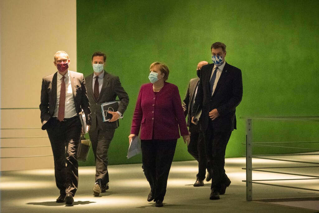 German Chancellor Angela Merkel , Bavaria's State Premier Markus Soeder and Berlin's mayor Michael Mueller arrive to give a press conference after a meeting of states' leaders on the coronavirus situation in Berlin on October 14, 2020. Stefanie Loos/Pool via REUTERS - RC2MIJ9ZNK58