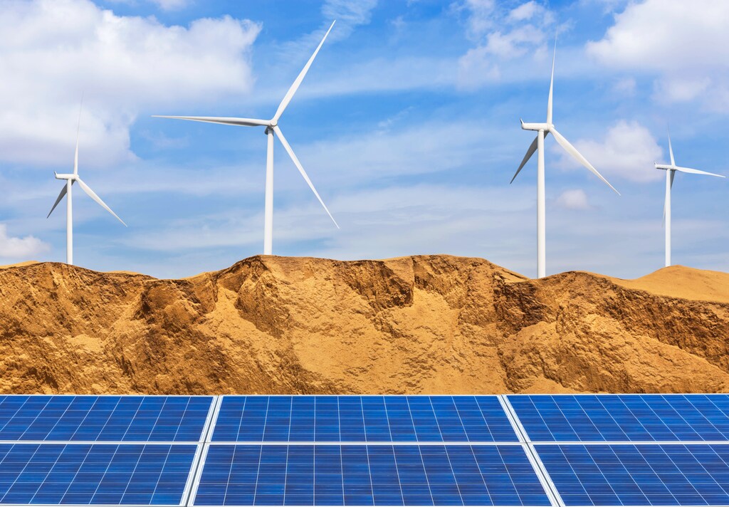 Photovoltaics solar cells and wind turbines generating electricity in desert: Diverse energy generation infrastructure can help meet growing electricity needs