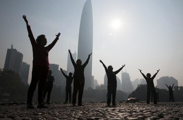 Residents do morning exercises at a park on a hazy day in Shenzhen, Guangdong province February 12, 2015. Nearly 90 percent of China's big cities failed to meet air quality standards in 2014, but that was still an improvement on 2013 as the country's "war on pollution" began to take effect, the environment ministry said on February 2. REUTERS/Stringer (CHINA - Tags: ENVIRONMENT SOCIETY) CHINA OUT. NO COMMERCIAL OR EDITORIAL SALES IN CHINA