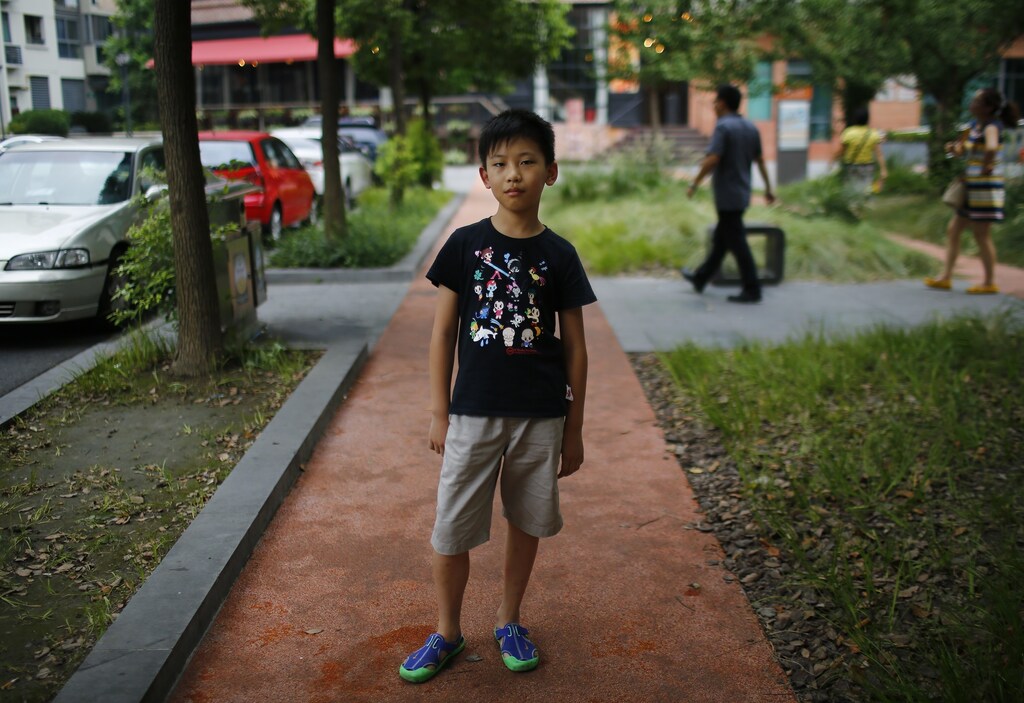 Yu Yan, who was born in 2004, poses for a photograph in Shanghai August 24, 2014. "I want to have someone to play with," said Yan. Reuters Photographer Carlos Barria photographed a person born in each year China?s one child policy has been in existence; from a man born in 1979, to a baby born in 2014, and asked them if they would have like to have siblings. China, the world's most populous country with nearly 1.4 billion people, says the country's one-child policy has averted 400 million births since 1980, saving scarce food resources and helping to pull families out of poverty. Couples violating the policy have had to pay a fine, or in some cases have been forced to undergo abortions. But late last year, China said it would allow millions of families to have two children, part of a plan to raise fertility rates and ease the financial burden on a rapidly ageing population. Picture taken August 24, 2014. REUTERS/Carlos Barria (CHINA - Tags: SOCIETY POLITICS PORTRAIT) ATTENTION EDITORS - PICTURE 12 OF 37 FOR WIDER IMAGE STORY '36 YEARS OF CHINA'S ONE CHILD POLICY'SEARCH 'BARRIA CHILD' FOR ALL PICTURES - RTR491R0