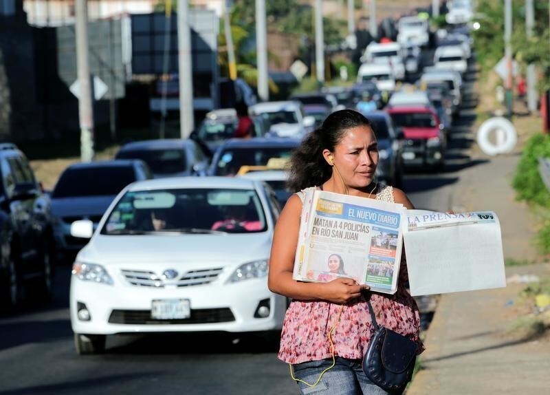 A street vendor sells La Prensa, a local newspaper showing a blank front page as a sign of protest against Daniel Ortega's government, in Managua, Nicaragua January 18, 2019. REUTERS/Oswaldo Rivas - RC1D39E06680