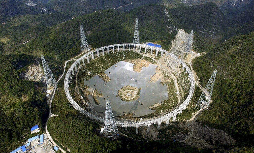 A 500-metre (1,640-ft.) aperture spherical telescope (FAST) is seen under construction among the mountains in Pingtang county, Guizhou province, China, November 26, 2015. The telescope, which will be the largest in the world, will be put in use by September 2016, according to local media. Picture taken November 26, 2015.