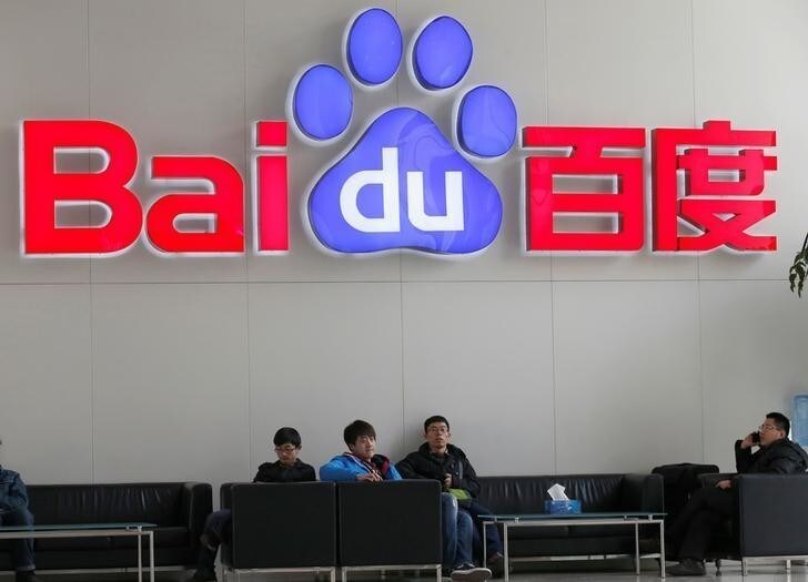 People sit in front of the company logo of Baidu at its headquarters in Beijing December 17, 2014. REUTERS/Kim Kyung-Hoon/File photo