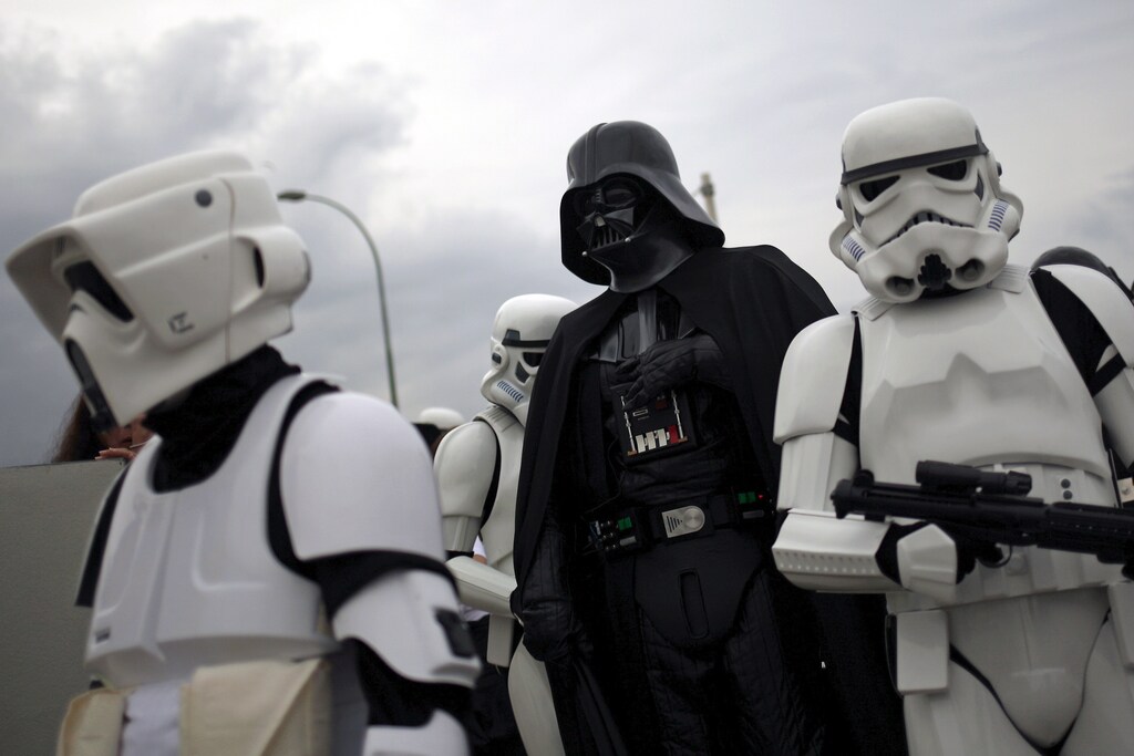 Members of the 501st Legion Spanish Garrison dress up as "Darth Vader" (C) and "Stormtroopers" from the movie "Star Wars" during a solidarity parade to spread the message of bone marrow donation and the fight against cancer, organized by the Luis Olivares Foundation in downtown Malaga, southern Spain, October 24, 2015. REUTERS/Jon Nazca - RTX1T2GS